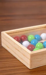 Close-up of polished solid wood frame and colorful beads on educational logic toy
