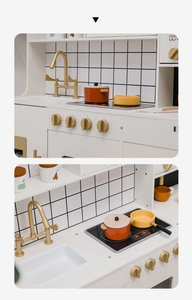 Detailed close-up of white wooden toy kitchen with golden faucet and cooking stove