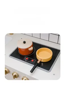Close-up of wooden toy stovetop with light-up burners, orange pot and yellow frying pan