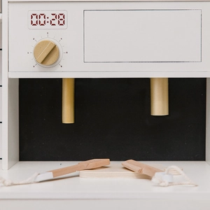 Minimalist wooden toy kitchen control panel with digital display and golden knob