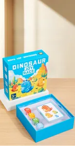 Detail of dinosaur board game set featuring colorful dice and educational game cards
