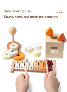 Macro shot of wooden xylophone, shape sorter box, and stacking rings in pastel tones