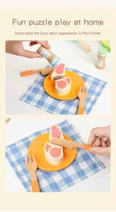 Close-up of wooden pretend play kitchen set with Velcro steak, knife, and toy tableware
