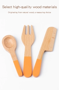 Detailed close-up of a three-piece wooden toy cutlery set with vibrant orange handles