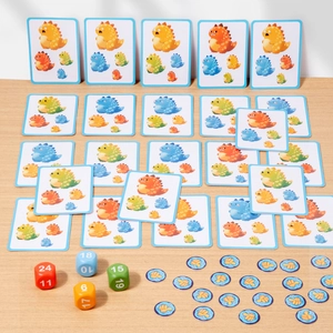 Kids dinosaur card board game with colorful 24-sided dice and reward tokens on a wooden table