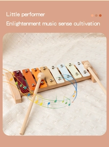 Detail view of 8-note wooden xylophone for kids on a textured white fabric background