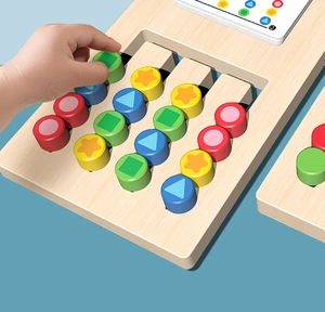 Detail of child hand moving colored wooden pegs on the logic thinking puzzle board