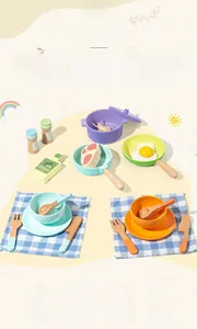 Detailed view of wooden play kitchen accessories including pans, steak, and mini seasonings