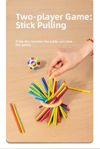 Close-up of hands playing the colorful wooden stick game with a natural wood ring