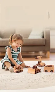 Detailed close-up of four wooden toy construction vehicles with natural wood grain texture