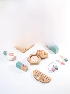 Flat lay of wooden pretend play makeup toy set with combs and accessories in soft pastel colors