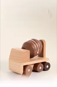 Detail of wooden cement mixer toy with rotating drum and polished natural wood texture