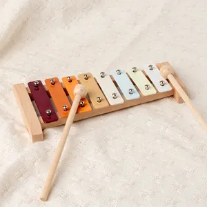 8-note colorful wooden xylophone with mallets on white texture background for music education