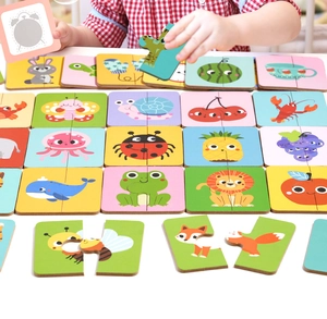 Macro shot of colorful animal puzzles and kids' hands playing for cognitive learning