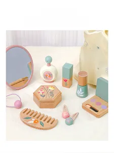 Close-up of wooden makeup toy set with comb, lipstick and accessories in a fabric bag