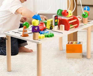 Detail of wooden activity table showing colorful bead maze and traffic maze tracks
