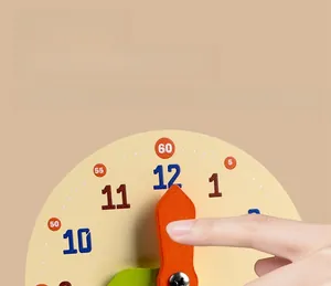 Macro view of hands adjusting orange pointers on a wooden educational clock for kids