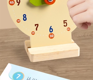 Close-up of a child using a wooden educational clock toy for learning time and numbers
