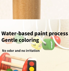 Detailed macro view of smooth wooden activity table with colorful beads and water-based paint
