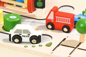 Close-up of wooden police car, fire truck and traffic lights on a Montessori activity board