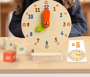 Close-up of wooden teaching clock set with blocks and cards for learning time