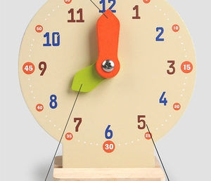 Macro detail of wooden educational clock with colorful hour and minute hands for kids
