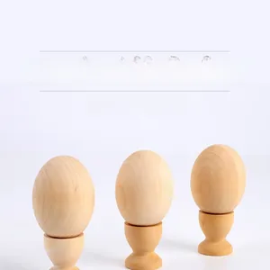 Detailed view of three DIY wooden simulation eggs with bases for creative painting