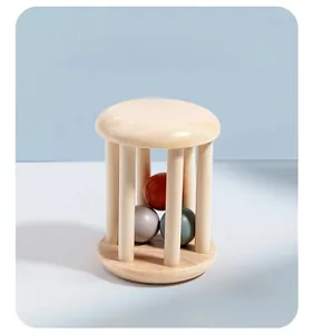 Macro detail of wooden cage rattle with colorful rolling balls for infant sensory play