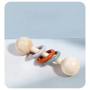 Detailed view of the three-ring wooden baby rattle with colorful smooth rings for grasping