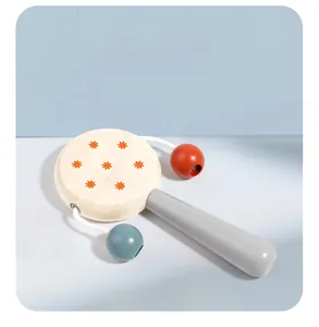 Detail of wooden baby rattle with orange flower pattern and colorful shaking beads