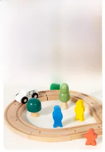 Wooden train track detail with colorful figures, toy car and a yellow parking sign