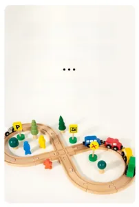 Close-up of wooden train track set with colorful carriages and scenery accessories