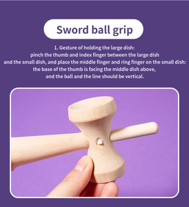 Detail view of the wooden kendama handle showing cup structure and finger placement