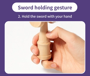 Detailed view of the wooden Kendama sword part showing correct hand holding gesture