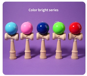 Five assorted bright colored kendama toys arranged neatly on a solid purple background