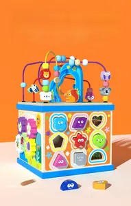 Detail of wooden activity cube with shape sorting blocks and bead maze toy