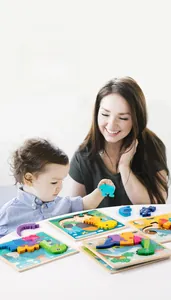Toddler playing with wooden 3D dinosaur puzzle showing parent-child interaction scene