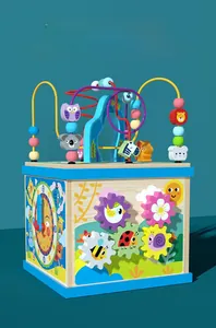 Detail view of colorful clock dial and spinning gears on a wooden activity cube for toddlers