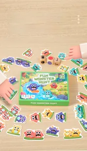FUN MONSTER HUNT board game set with monster cards and dice on a wooden table