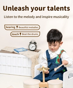 Detail of child playing wooden drum set featuring natural wood texture and metal cymbal