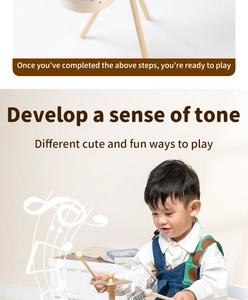 Close-up of wooden drum set for toddlers with metal cymbals and drumsticks for music play