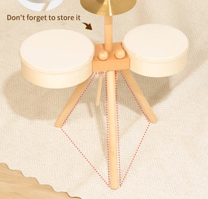 Close-up of wooden drum set for kids featuring built-in drumstick storage on the tripod