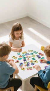 Kids playing interactive monster catching board game with colorful tiles and wooden dice