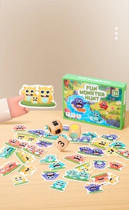 Detailed view of colorful monster cards and wooden dice for early education game