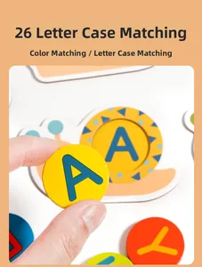 Close-up of hands pairing wooden alphabet pieces on a colorful snail puzzle board