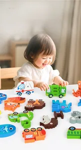 Close-up of wooden alphabet puzzle toys with colorful animal and vehicle patterns