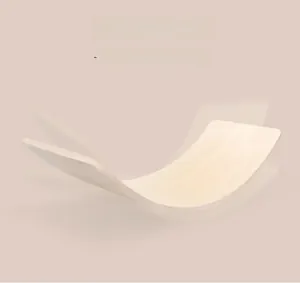Close-up of curved wooden balance board showing natural solid wood grain texture