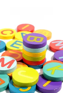 Macro shot of smooth colorful wooden alphabet blocks showing premium polished finish