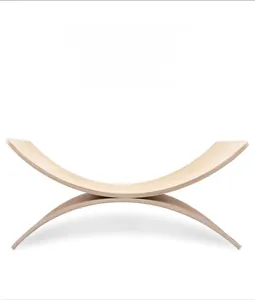 Detail of wooden balance board showing natural grain texture and curved dual-side design
