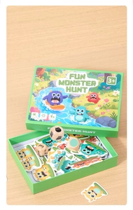 Close-up of Fun Monster Hunt board game cards and wooden dice on a light wooden background